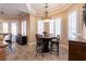 Dining area features a round table and chairs, modern light fixture, and shuttered windows at 7718 Willow Cove Cir, Las Vegas, NV 89129