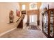 Grand foyer featuring high ceilings, elegant chandelier, and staircase at 7718 Willow Cove Cir, Las Vegas, NV 89129