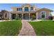 Beautiful home showcasing a brick pathway and lush green lawn at 7718 Willow Cove Cir, Las Vegas, NV 89129