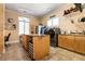Bright laundry room boasts stainless steel washer and dryer, cabinetry, and island at 7718 Willow Cove Cir, Las Vegas, NV 89129