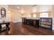 Upstairs living room with hardwood floors, ceiling fan, large windows, and lots of natural light at 7718 Willow Cove Cir, Las Vegas, NV 89129