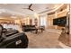 Open living room with ceiling fan, tile flooring, built-in shelves, and natural lighting at 7718 Willow Cove Cir, Las Vegas, NV 89129