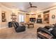 Living room features a fireplace, built-in shelving, and large windows with plantation shutters at 7718 Willow Cove Cir, Las Vegas, NV 89129