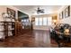 Upstairs living room with hardwood floors, ceiling fan, large windows, and lots of natural light at 7718 Willow Cove Cir, Las Vegas, NV 89129