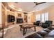 Cozy living room features a fireplace, tile flooring, and comfortable leather seating at 7718 Willow Cove Cir, Las Vegas, NV 89129