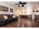 Upstairs living room with hardwood floors, ceiling fan, large windows, and lots of natural light at 7718 Willow Cove Cir, Las Vegas, NV 89129