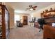 Spacious home office with natural lighting, decorative ceiling fan, and wall to wall carpet at 7718 Willow Cove Cir, Las Vegas, NV 89129