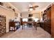 Well lit home office area with carpet, desk, shelving, and ceiling fan at 7718 Willow Cove Cir, Las Vegas, NV 89129