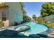 Beautiful backyard pool and spa surrounded by lush landscaping creates a private oasis for relaxation and enjoyment at 7718 Willow Cove Cir, Las Vegas, NV 89129