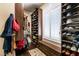 Walk-in closet with hats and shoes lining shelves, coat rack, bench, and natural light at 7718 Willow Cove Cir, Las Vegas, NV 89129