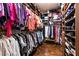 Walk-in closet displaying organized clothes and shoes on rods and shelves at 7718 Willow Cove Cir, Las Vegas, NV 89129