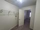 Walk-in closet features a door leading to bedroom with wire shelves, and neutral color palette at 7730 Secret Shore Dr # 207, Las Vegas, NV 89128