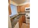 Kitchen features granite countertops, tile flooring, modern appliances, and light wood cabinetry at 7730 Secret Shore Dr # 207, Las Vegas, NV 89128