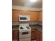 Kitchen features granite countertops, modern appliances, and light wood cabinetry at 7730 Secret Shore Dr # 207, Las Vegas, NV 89128