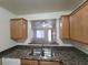 Kitchen area features stainless steel sink, granite countertops, and wooden cabinets at 7730 Secret Shore Dr # 207, Las Vegas, NV 89128