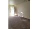 Open-concept living space with lots of light, carpet flooring and fresh paint at 7730 Secret Shore Dr # 207, Las Vegas, NV 89128