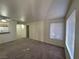 Inviting living room with natural light from window; neutral color palette and open space to kitchen at 7730 Secret Shore Dr # 207, Las Vegas, NV 89128