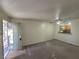 Bright living room featuring an open layout with connecting view to the kitchen and outdoor access at 7730 Secret Shore Dr # 207, Las Vegas, NV 89128
