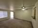 Living room featuring carpet flooring, neutral color palette, and a ceiling fan with lights at 7730 Secret Shore Dr # 207, Las Vegas, NV 89128
