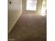 Spacious living area featuring wall to wall carpeting and a window for natural light at 7730 Secret Shore Dr # 207, Las Vegas, NV 89128