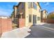 View of the home's backyard and stucco walls. The yard has a concrete patio and gate at 8109 Retriever Ave, Las Vegas, NV 89147