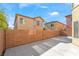 A fenced in backyard view showcases the concrete patio and block wall with shade trees at 8109 Retriever Ave, Las Vegas, NV 89147