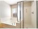 Clean bathroom featuring a tub and shower with glass doors at 8109 Retriever Ave, Las Vegas, NV 89147