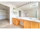 A well-lit bathroom boasts dual sinks and access to the walk-in closet at 8109 Retriever Ave, Las Vegas, NV 89147