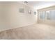 Bright bedroom with large windows, neutral carpet, and a view of the outdoors at 8109 Retriever Ave, Las Vegas, NV 89147