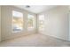 Bright, carpeted bedroom offers neutral walls and three large windows for natural lighting at 8109 Retriever Ave, Las Vegas, NV 89147
