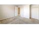 This carpeted bedroom has a closet and doors opening to a hallway, providing space for rest at 8109 Retriever Ave, Las Vegas, NV 89147
