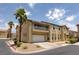 Two-story home with a balcony over the garage and a well-maintained front yard with palm trees at 8109 Retriever Ave, Las Vegas, NV 89147