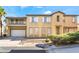 Two-story home featuring tan stucco, a two-car garage, and a small upstairs patio at 8109 Retriever Ave, Las Vegas, NV 89147