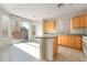 Well-lit kitchen features granite counters, an island, and sliding door access to the backyard at 8109 Retriever Ave, Las Vegas, NV 89147