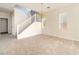 Bright, open living room with neutral carpet and a staircase to the upper level at 8109 Retriever Ave, Las Vegas, NV 89147