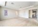 Spacious main bedroom featuring neutral paint, carpet, and a tray ceiling at 8109 Retriever Ave, Las Vegas, NV 89147