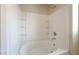Relaxing tub-shower combo with tiled walls and recessed shelving for bath essentials at 8109 Retriever Ave, Las Vegas, NV 89147