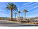 A sign welcomes people to the community featuring palm trees and manicured landscaping at 8255 Las Vegas Blvd # 117, Las Vegas, NV 89123