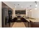 Well-equipped kitchen with black appliances, granite counters and sleek, dark cabinetry at 8255 Las Vegas Blvd # 117, Las Vegas, NV 89123