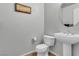 Simple half-bathroom featuring a pedestal sink, toilet, and decorative wall art at 8255 Las Vegas Blvd Blvd # 719, Las Vegas, NV 89123
