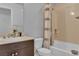 Cozy bathroom featuring a shower-tub combo with neutral tile and dark cabinets at 8255 Las Vegas Blvd Blvd # 719, Las Vegas, NV 89123