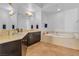 Modern bathroom with a soaking tub, dark wood cabinets, and double sinks at 8255 Las Vegas Blvd Blvd # 719, Las Vegas, NV 89123