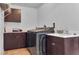 A functional laundry room with dark wood cabinets, sink, and modern washer/dryer at 8255 Las Vegas Blvd Blvd # 719, Las Vegas, NV 89123