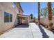 A wide, paved backyard, partially covered patio, and low-maintenance landscaping at 829 Dancing Vines Ave, Las Vegas, NV 89183