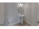Small, neutral colored bathroom featuring a pedestal sink and a standard toilet at 829 Dancing Vines Ave, Las Vegas, NV 89183