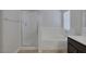 Bright bathroom featuring a shower with glass door and a separate soaking tub under a window at 829 Dancing Vines Ave, Las Vegas, NV 89183