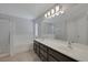 Primary bathroom showcasing double sinks, bathtub, and a glass shower at 829 Dancing Vines Ave, Las Vegas, NV 89183