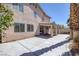 The backyard shows off a covered patio, sliding door access, and an expansive paved area at 829 Dancing Vines Ave, Las Vegas, NV 89183