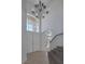Bright foyer with a grand staircase, travertine floors, and a double door entrance at 829 Dancing Vines Ave, Las Vegas, NV 89183