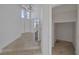 Bright foyer with high ceilings, chandelier, staircase, closet, and tile flooring at 829 Dancing Vines Ave, Las Vegas, NV 89183
